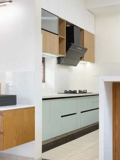 A wider view showing the breakfast bar with a fluted wood panel and the floating vanity. The design ensures a cohesive look across the different functional zones.