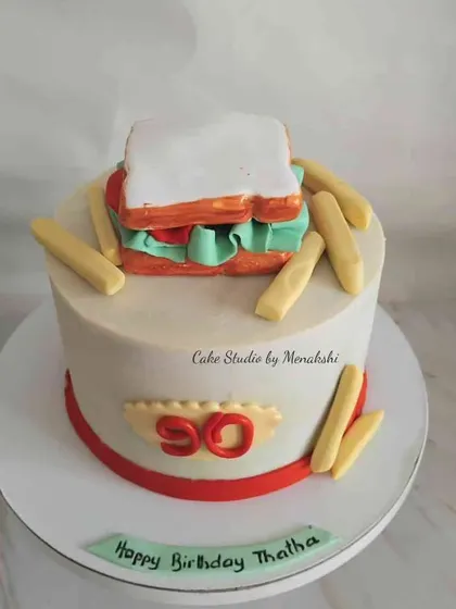 For a 90th birthday, I made this cake that looks like a sandwich and french fries. It's a fun and personal way to celebrate someone's favorite meal.