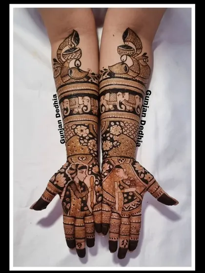 A classic bridal design featuring bride and groom portraits. The intricate patterns and traditional motifs like peacocks and elephants complete the look.