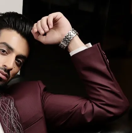 A glimpse of our statement tuxedo in a rich burgundy. We believe in moving beyond the basic, using unique colors and embroidered details to redefine evening wear.