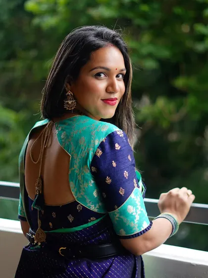 The back view of Supritha's blouse, highlighting the unique patchwork design and perfect fit.