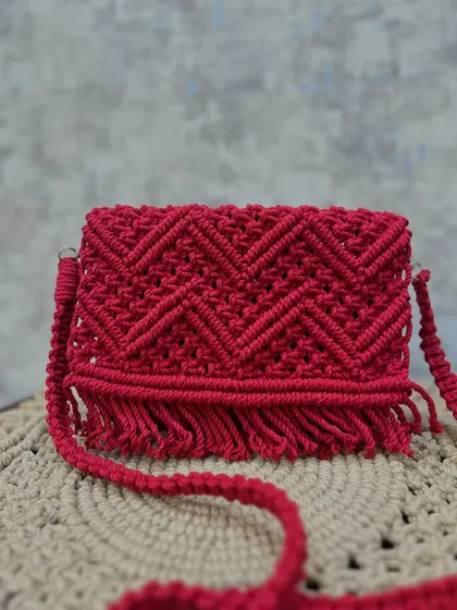 Another beautiful shot of the red chevron sling bag, ready to add some artisanal charm to your look.