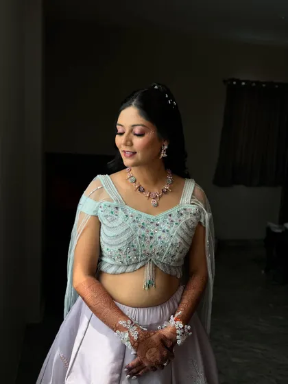 My bride Ankita basking in the sunlight during her Haldi carnival. The natural light makes her dewy makeup and pink eyeshadow pop beautifully.