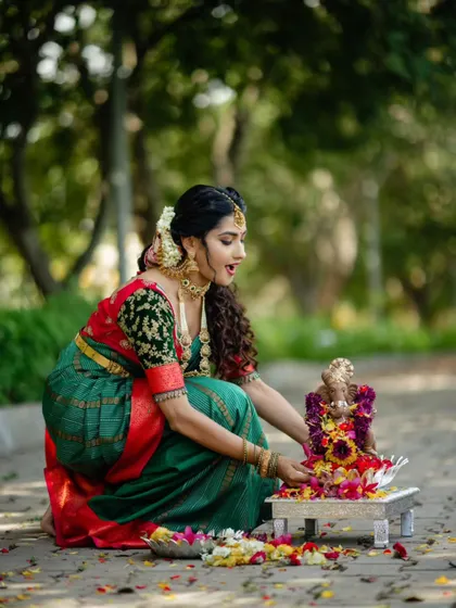 This is the same beautiful green and red saree, a classic choice for any festive pooja or ceremony.