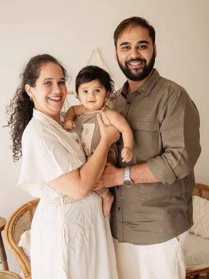 A classic family pose. This portrait captures the family looking together, creating a timeless memory of this special stage.