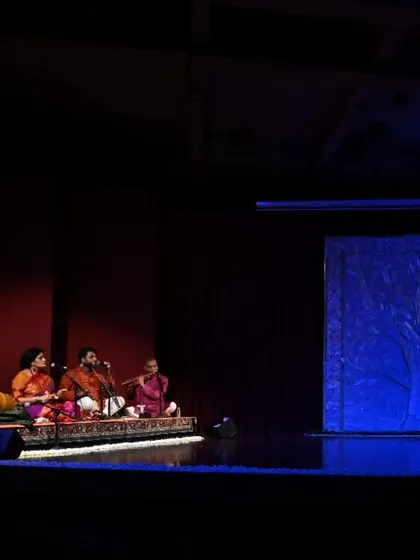 The stage is set for Stuti Mukherjee's arangetram. The live orchestra is seated and ready, their presence creating an atmosphere of anticipation and festive energy before the performance begins.