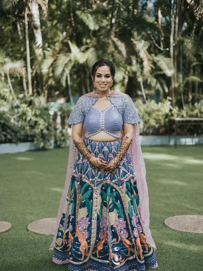 The full view of this fun and colorful Mehendi look. The makeup is kept fresh to balance the vibrant, quirky lehenga.