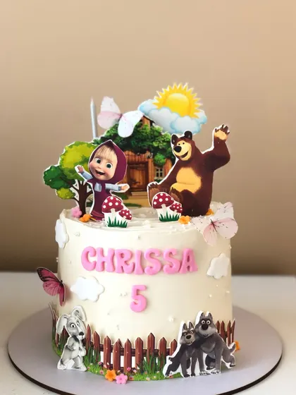 A delightful Masha and the Bear cake, bringing the animated series to life with edible characters in a forest setting.
