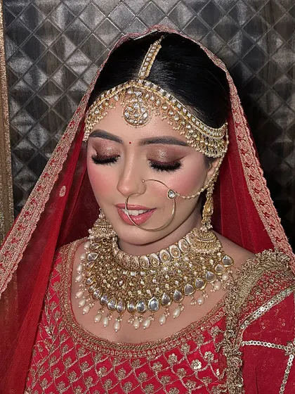 The complete bridal portrait. Her traditional matha patti and nath are balanced with a soft yet defined makeup look.