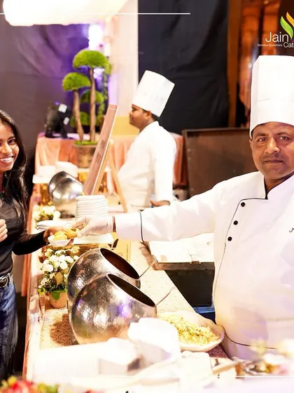 Capturing smiles with each flavourful experience. A happy guest gives a thumbs-up to our chef at a live counter, a testament to our delicious food and friendly service.