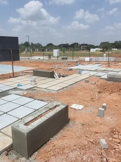 Laying the foundation and paving for a basketball court at Aamby City. This photo shows the initial stages of creating a recreational zone, with careful attention to levels and layout.