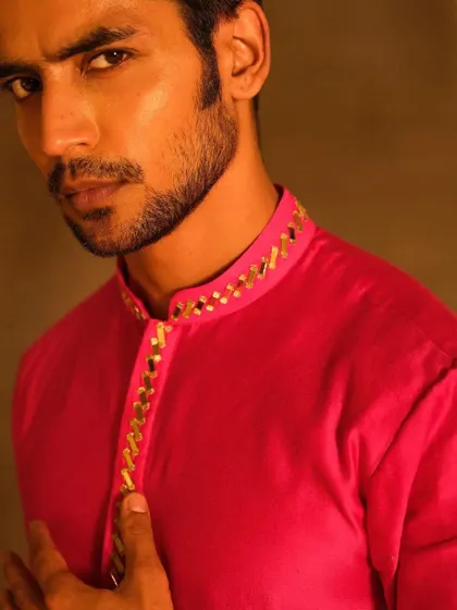A close-up portrait from the Nayantaara campaign. The grooming is clean and sharp, defining the model's jawline and brows to create a strong, masculine look for this festive wear shoot.