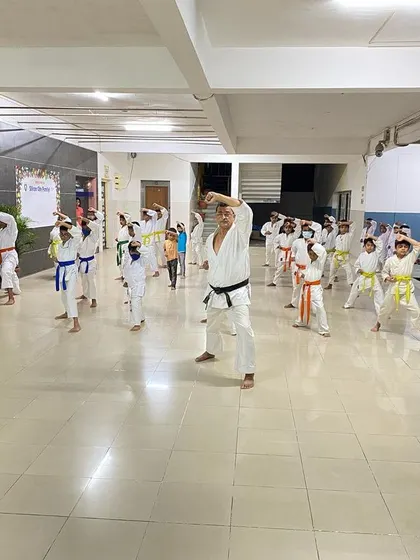 Students practice age-uke (upper block) in unison. Repetition of these fundamental movements builds muscle memory and discipline.