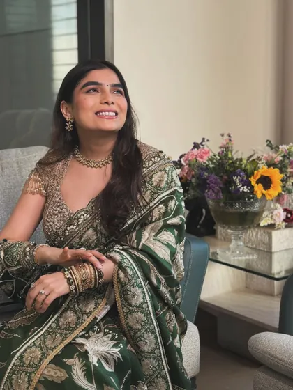 This look is a perfect example of traditional elegance. The deep green saree paired with a classic gold necklace creates a sophisticated and timeless style.