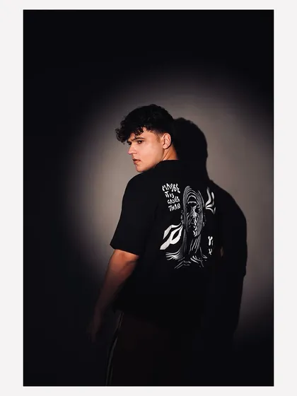 A studio fashion portrait using a spotlight effect to create a dramatic, high-contrast look. This technique is great for lookbooks and brand campaigns that need a bold, modern aesthetic.