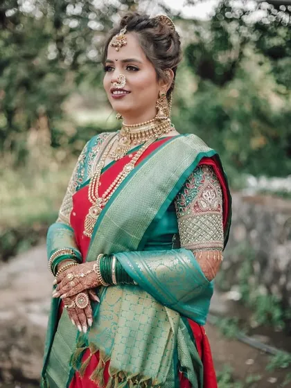 The bride Pranali looking stunning in her traditional Maharashtrian attire, with a beautiful natural backdrop.