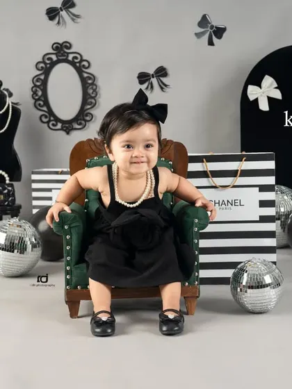 A full-frontal shot of our little model in her chair. Her happy expression is just priceless.