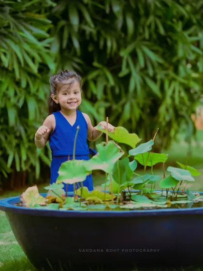 This shot captures the same little girl's infectious smile and happy energy. Outdoor sessions are perfect for letting toddlers move around and express themselves freely.
