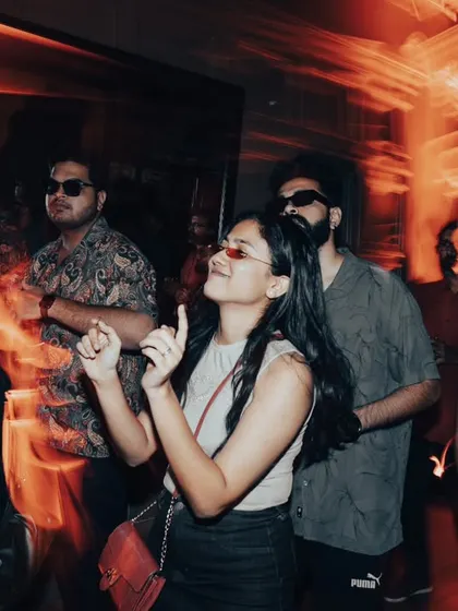 Dancing with friends under the warm lights of the party.