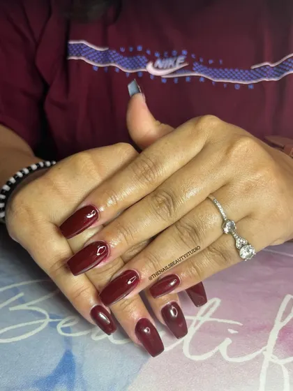There's a shade of red for everyone. This classic, deep red on coffin-shaped nails is always a powerful choice.