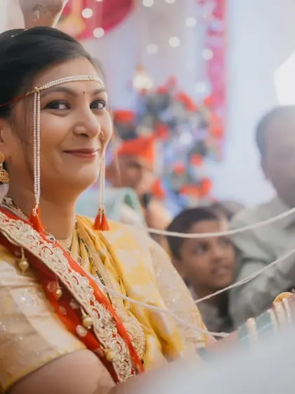 The bride's beautiful smile as the antarpat is lowered, revealing her groom for the first time during the ceremony.