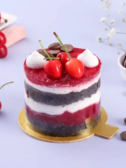 A mini version of our popular Black Forest cake. This individual dessert has layers of chocolate sponge, fresh cream, and a tangy cherry compote, topped with fresh cherries.