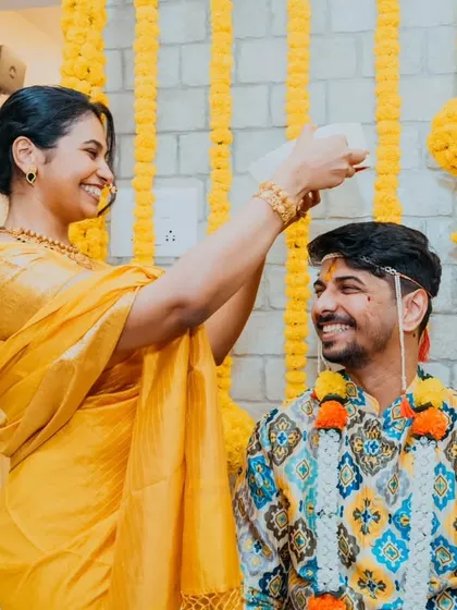 A moment of blessing and ritual as holy water is poured over the groom during his Haldi ceremony.