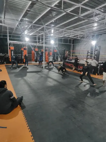 A wide shot of our Noida Extension facility during a group session. It's a large, open space where our community comes together to train.