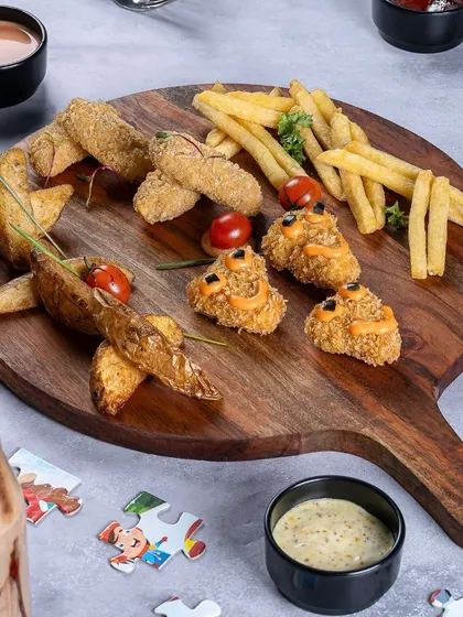 A kid-friendly platter with all their favorites: potato wedges, french fries, and chicken nuggets.