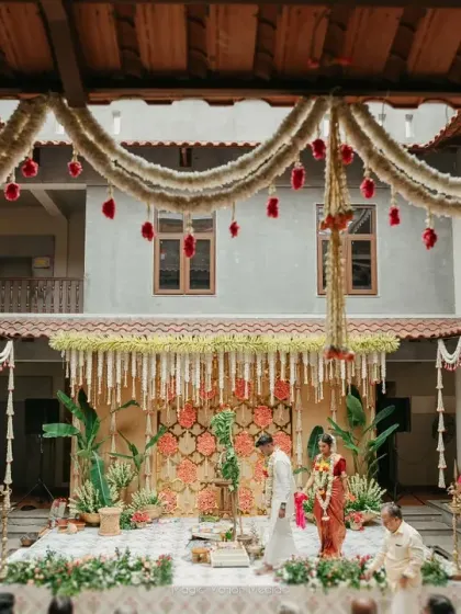 A traditional Chettinad house offers a story in every corner. We designed this courtyard wedding to honor its cultural beauty, using classic flower arrangements and brass elements to create an authentic and intimate ceremony space.