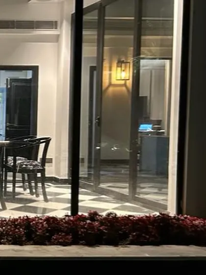 A peek into the winter dining room through the 10-foot high slimline glass doors. This feature floods the space with natural light and provides an uninterrupted connection to the outdoors.