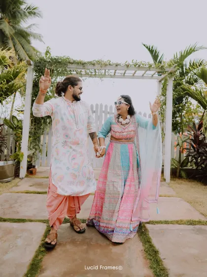 The couple dances their way into the party, hand-in-hand and full of life.