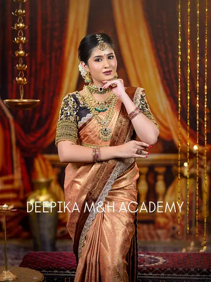 Another elegant pose of the bride, showing off the beautiful drape of the saree and the detailed embroidery on the blouse sleeves.