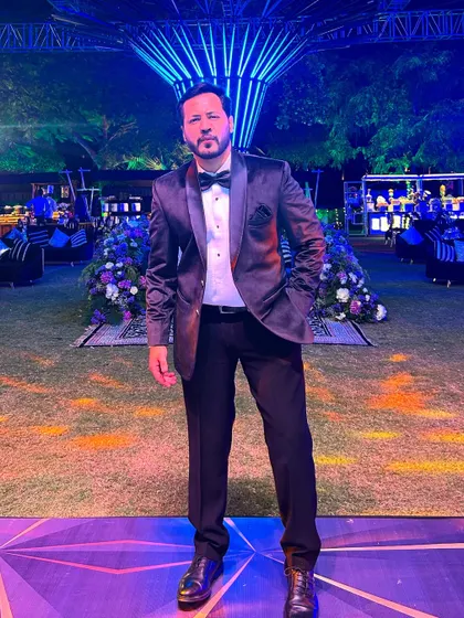 A full-length shot showcasing my formal Sangeet attire against the backdrop of an elaborate and beautifully lit wedding venue.