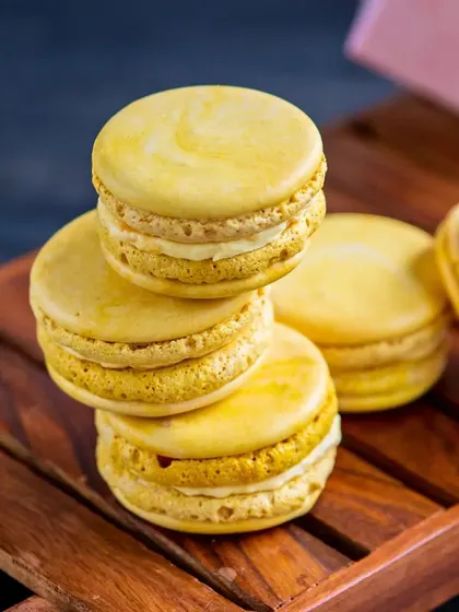 Bite-sized bliss. Our Mango Cheesecake Macarons have a crisp shell and a creamy mango cheesecake filling, capturing the essence of two of our favorite desserts in one bite.
