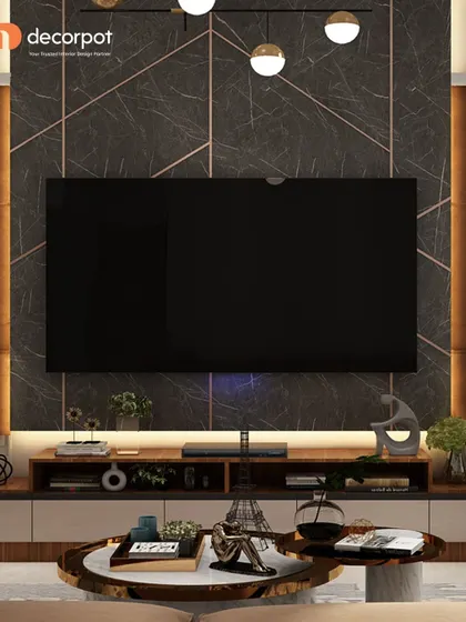 This TV unit features a dark, dramatic marble-finish wall with metallic inlays. The simple wooden console provides a warm contrast, while the modern pendant lights add a touch of artistic flair.