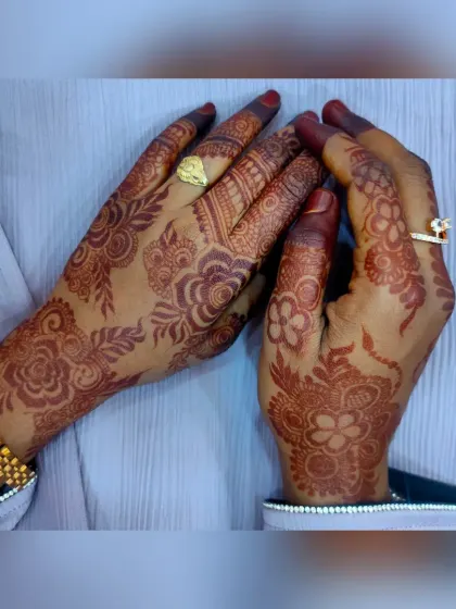 Another view of the same intricate henna design, showing how the pattern flows from the wrist to the fingers. The rich brown stain is consistent across both hands, a result of my carefully prepared organic paste.
