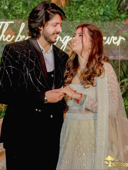 A candid shot of the couple sharing a laugh, showing their genuine happiness.