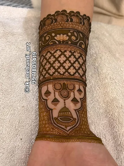 A beautiful arm band design with hanging 'kalash' (ceremonial pots), a traditional and auspicious motif.