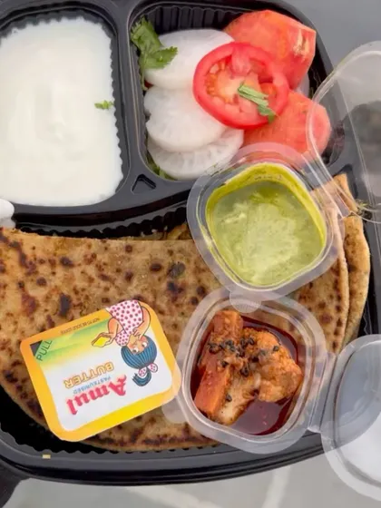 My popular Gobhi Paratha Meal is a complete treat. It comes with a generously stuffed gobhi paratha, creamy dahi, tangy pickle, fresh green chutney, a crisp salad, and a pat of Amul butter to top it all off.