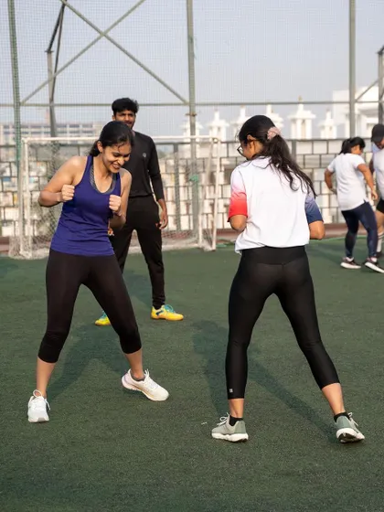 Members participate in a boxing bootcamp on our rooftop turf, combining high-intensity training with fresh air and city views.