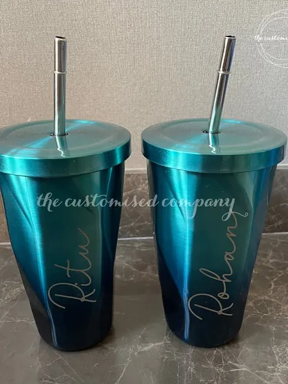 This personalized chrome tumbler with a matching steel straw has a stunning iridescent finish. It's a stylish and modern drinkware option that can be customized with a name.