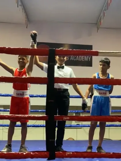 A young champion in the making. This photo captures the moment of victory for one of our Under-14 boxers. Our youth program focuses on building skills and confidence from a young age.