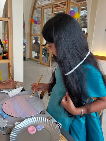 A young girl carefully adds color to her artwork. I love watching the focus and imagination that goes into every piece.