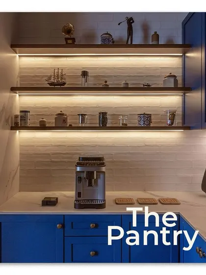 The office pantry, highlighted in Elle Decor. I chose a bold blue for the cabinetry to add a pop of color, while the under-shelf lighting provides both functional task lighting and a beautiful ambient glow on the curated decor.