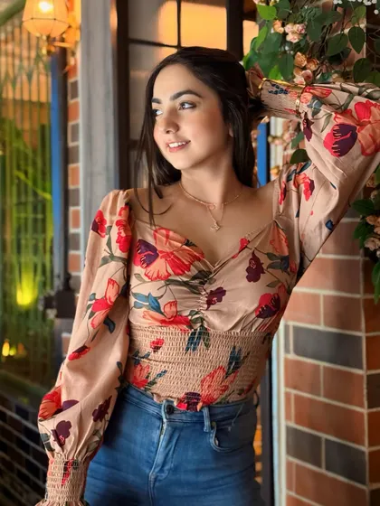 Don't mistake my kindness for weakness. A confident pose in a floral top, perfect for a cafe visit.