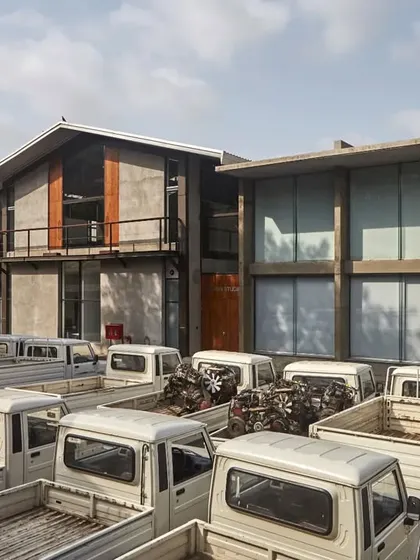 An exterior view of the repurposed industrial sheds that form the Automobile Design Studio. The project showcases our approach to adaptive reuse, respecting the original character of the buildings while updating them for a new, high-tech purpose.