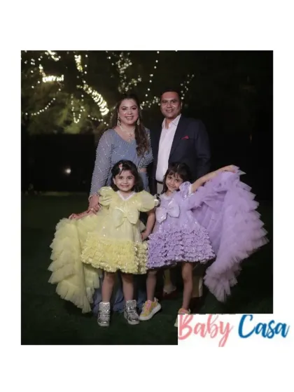 Sisterhood and celebration. We designed these beautiful yellow and lavender ruffled gowns for two sisters attending a family wedding, ensuring they both shined in their coordinated yet unique party dresses.