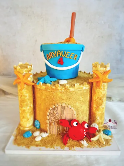 Have your castle and eat it too! A sandcastle cake for a beach-themed party, complete with edible sand, shells, and a friendly crab.