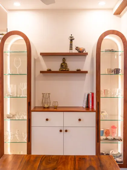 This crockery unit features two arched display cabinets with integrated vertical lighting to showcase the glassware inside.